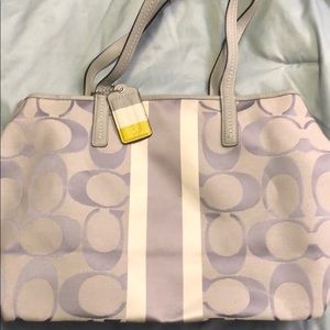 Gray and white coach purse